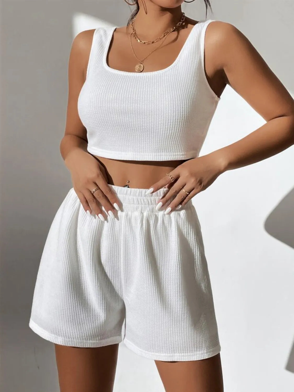 Model posing in an olive green full size wide strap tank and shorts set plus size