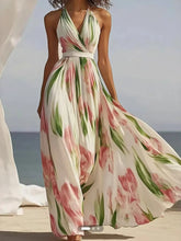 Floral print halter neck maxi dress with a flowing skirt and a vibrant botanical pattern.