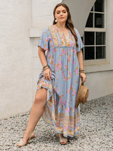  Plus size tie neck maxi dress in a colorful print with flowing flutter sleeves.