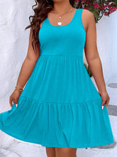  Plus size scoop neck tank dress featuring a flowing tiered skirt design.