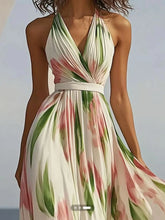 Floral print halter neck maxi dress with a flowing skirt and a vibrant botanical pattern.
