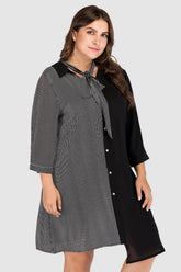  Plus size tie-neck dress featuring a modern striped color block pattern and adjustable neck tie.