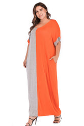 Plus size tee dress with pockets featuring a modern color block design and short sleeves.