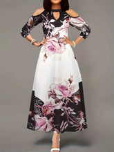  Plus size printed dress with a vibrant all-over pattern and cutout cold shoulders.