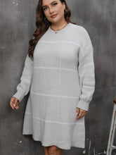  Plus size long sleeve sweater dress with a comfortable round neck in a cozy knit fabric.