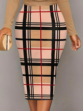 Model posing in an autumn-toned houndstooth Plus Size Plaid Long Sleeve Mini Dress